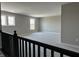 Upstairs loft with neutral walls, plush carpet, and ample natural light from multiple windows at 750 Oakleaf Dr, Greenfield, IN 46140