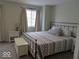Comfortable bedroom with a metal frame bed, neutral decor, carpet, and natural light at 8148 Shores Edge Way, Indianapolis, IN 46237
