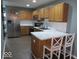 Modern kitchen with stainless steel appliances, wood cabinets, and marble countertops at 8148 Shores Edge Way, Indianapolis, IN 46237