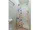 Clean shower with bright, patterned curtain in a light-colored bathroom at 11131 N State Road 9, Fountaintown, IN 46130