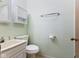 Compact bathroom featuring a sink, toilet, and a cabinet for storage at 11131 N State Road 9, Fountaintown, IN 46130