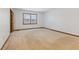A carpeted bedroom with a window allows natural light to brighten the area at 11131 N State Road 9, Fountaintown, IN 46130