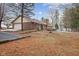 View of brick house exterior featuring back yard and detached garage at 11131 N State Road 9, Fountaintown, IN 46130