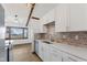 Eat-in kitchen area featuring white cabinets, gray backsplash, and stainless steel appliances at 11131 N State Road 9, Fountaintown, IN 46130