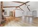 A large, open living room featuring wood floors, brick fireplace, and a view to the backyard at 11131 N State Road 9, Fountaintown, IN 46130