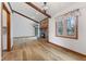Open living room showcasing wood beams, a brick fireplace, and hardwood flooring at 11131 N State Road 9, Fountaintown, IN 46130