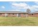 Brick townhomes with patios and a spacious lawn in the backyard at 120 Saratoga Way, Anderson, IN 46013
