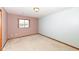 Cozy carpeted bedroom with a large window and neutral colored walls, offering a tranquil and relaxing space at 120 Saratoga Way, Anderson, IN 46013
