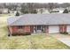 Charming red brick townhouse with a well-maintained lawn and attached garage at 120 Saratoga Way, Anderson, IN 46013