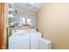 Functional laundry room featuring a washer, dryer, open shelving and a window for natural light at 120 Saratoga Way, Anderson, IN 46013