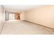Spacious carpeted living room with neutral walls and access to the kitchen at 120 Saratoga Way, Anderson, IN 46013