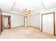 Large main bedroom with tray ceiling, fan, neutral carpet and two closet doors at 120 Saratoga Way, Anderson, IN 46013