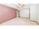 Carpeted main bedroom with a neutral color scheme, a tray ceiling, and a ceiling fan at 120 Saratoga Way, Anderson, IN 46013