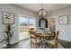 Dining area features a round table, modern lighting, and sliding glass doors to an outdoor deck with views of the lake at 19763 Atwater Ave, Sheridan, IN 46069