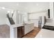 Bright kitchen with white cabinets, stainless steel appliances and a view of the stairs at 19763 Atwater Ave, Sheridan, IN 46069