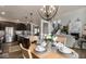 Open kitchen with island, stainless appliances, and breakfast table is adjacent to the living room and staircase at 19763 Atwater Ave, Sheridan, IN 46069