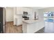 White kitchen features an island, stainless steel appliances, and a view to the backyard at 19763 Atwater Ave, Sheridan, IN 46069