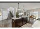 Open concept kitchen featuring an island with pendant lighting, stainless steel appliances, and a view of the stairs at 19763 Atwater Ave, Sheridan, IN 46069