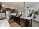 Kitchen with dark cabinets, stainless steel appliances, large island and views to the living room at 19763 Atwater Ave, Sheridan, IN 46069