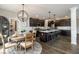 Open-concept kitchen features dark cabinets, stainless steel appliances, and a large island with bar seating at 19763 Atwater Ave, Sheridan, IN 46069