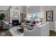 Bright living room features a fireplace, tall windows with natural light and modern furniture at 19763 Atwater Ave, Sheridan, IN 46069