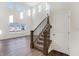 Light and airy living room with tall windows, hardwood floors, and a staircase with dark wood railings at 19763 Atwater Ave, Sheridan, IN 46069