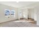 Spacious living room filled with natural light, showcasing neutral tones, plush carpeting, and hardwood flooring at 19763 Atwater Ave, Sheridan, IN 46069