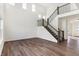 Bright, open living room with staircase, hardwood floors and natural light flooding through tall windows at 19763 Atwater Ave, Sheridan, IN 46069