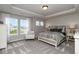 Comfortable main bedroom featuring a tray ceiling, large windows, and stylish furnishings at 19763 Atwater Ave, Sheridan, IN 46069