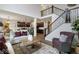 Open-concept living space with hardwood floors, a modern staircase, and a view to the kitchen at 19763 Atwater Ave, Sheridan, IN 46069