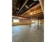 Unfinished basement with exposed ceiling, concrete floors and insulation, offering potential for customization at 1986 Mccormick Dr, Greenwood, IN 46143