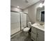 Modern bathroom with a glass-enclosed shower, white subway tile, and bright vanity at 1986 Mccormick Dr, Greenwood, IN 46143