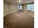 A well-lit, carpeted bedroom with several windows offering great light and a comfortable feel at 1986 Mccormick Dr, Greenwood, IN 46143