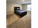 Well-lit bedroom features neutral walls, plush carpet, and a comfortable bed with a classic headboard at 1986 Mccormick Dr, Greenwood, IN 46143