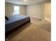 Neutral bedroom features neutral walls, plush carpet, and a comfortable bed with a classic headboard at 1986 Mccormick Dr, Greenwood, IN 46143