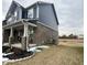 Side view of the house, showcasing the brickwork, siding, and well-maintained lawn at 1986 Mccormick Dr, Greenwood, IN 46143