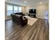Bright living room featuring hardwood floors, a large sectional, and ample natural light at 1986 Mccormick Dr, Greenwood, IN 46143