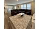 Open-concept living room with hard wood floors, a sectional, and seamless flow to the kitchen at 1986 Mccormick Dr, Greenwood, IN 46143