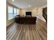 Well-lit living room with hard wood floors, a sectional, and large windows at 1986 Mccormick Dr, Greenwood, IN 46143
