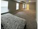 A spacious main bedroom with plush carpet features ample natural light and an ensuite bathroom at 1986 Mccormick Dr, Greenwood, IN 46143