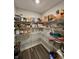 Organized pantry with ample shelving for all your storage needs and dark wood-look flooring at 1986 Mccormick Dr, Greenwood, IN 46143