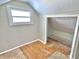 Small attic nook featuring hardwood floors, white-painted walls, and white trim at 210 S West St, Paragon, IN 46166