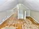 Attic with half wall, featuring hardwood floors and white-painted walls at 210 S West St, Paragon, IN 46166