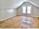 Cozy attic space with hardwood floors, natural light from windows, and painted walls at 210 S West St, Paragon, IN 46166