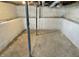 Unfinished basement featuring concrete floor, painted cinder block walls, and support beams, offering potential for renovation at 210 S West St, Paragon, IN 46166