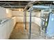 Spacious unfinished basement with concrete floors, support beams, and a utility unit, offering potential for customization at 210 S West St, Paragon, IN 46166