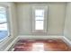 Bedroom featuring hardwood floors, bright windows, and neutral paint, awaiting personal touches at 210 S West St, Paragon, IN 46166