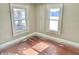 Bedroom with two large windows, hardwood floors, and light-colored walls, offering ample sunlight at 210 S West St, Paragon, IN 46166