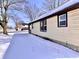 Charming home featuring vinyl siding, dark trim, and snow covered yard at 210 S West St, Paragon, IN 46166