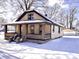 Inviting craftsman style home with brick porch supports, vinyl siding and detached garage at 210 S West St, Paragon, IN 46166